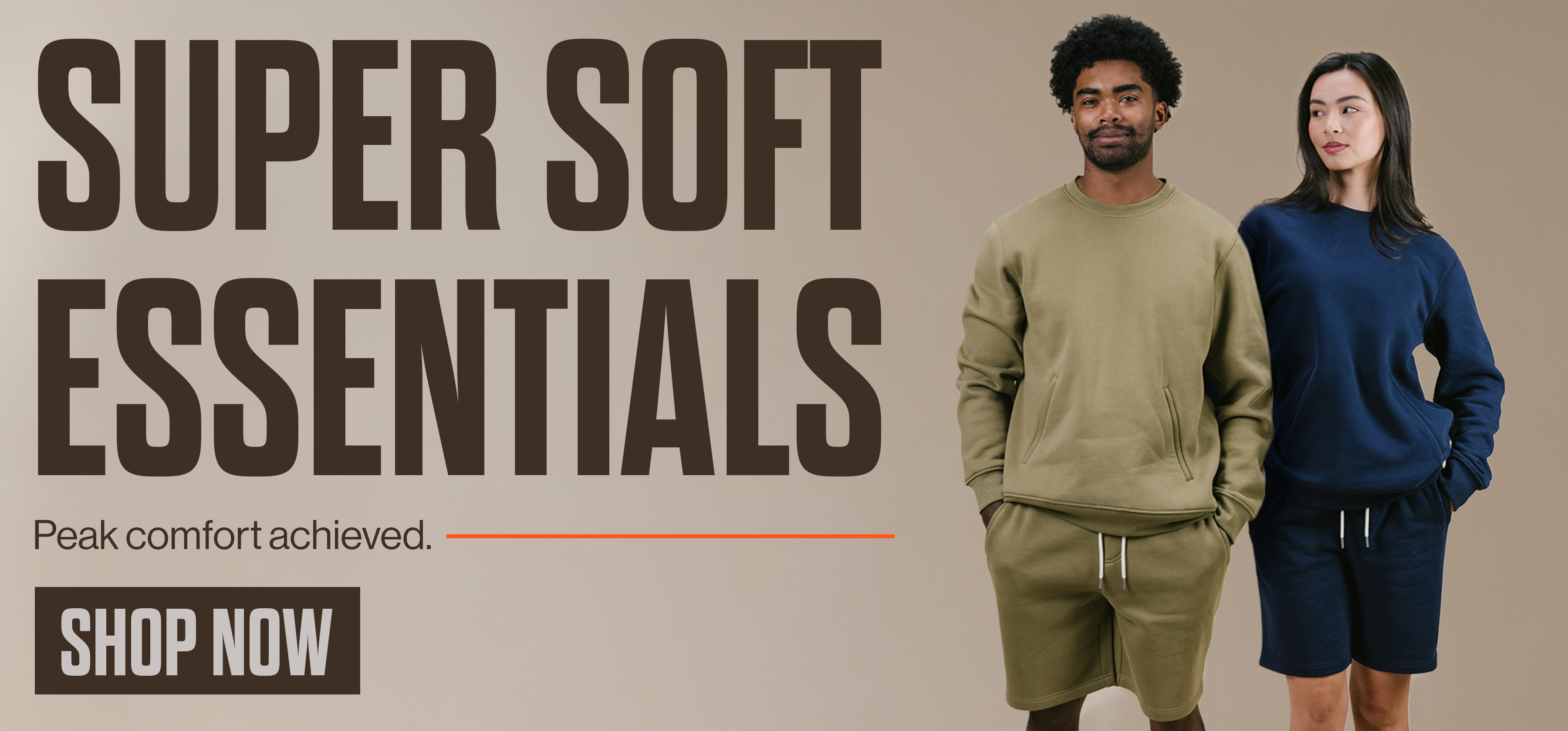 Two models wearing Super Soft Essentials fleece crewnecks and shorts in olive and navy, with the text “Peak comfort achieved” and a Shop Now button.